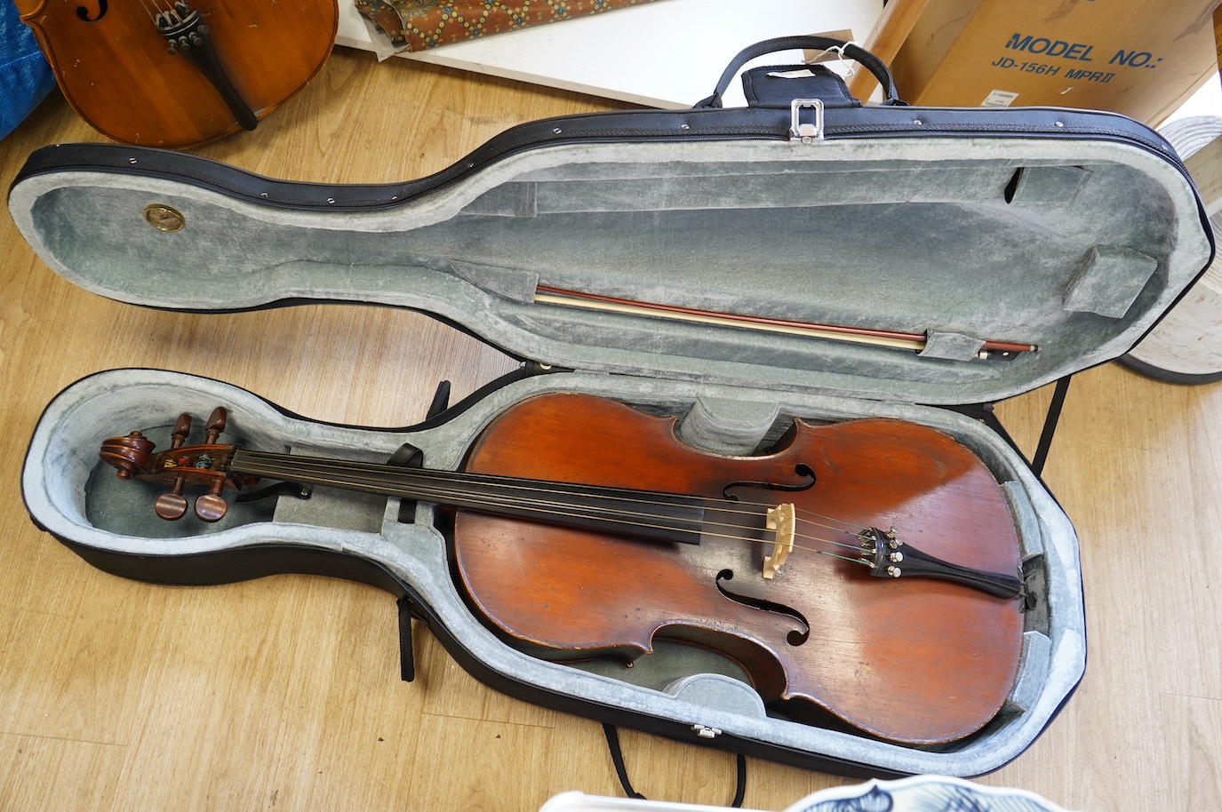 An early 19th century cello with a Stradivarius label, body 76cm, with a P&H bow, in a good modern case. Condition - poor